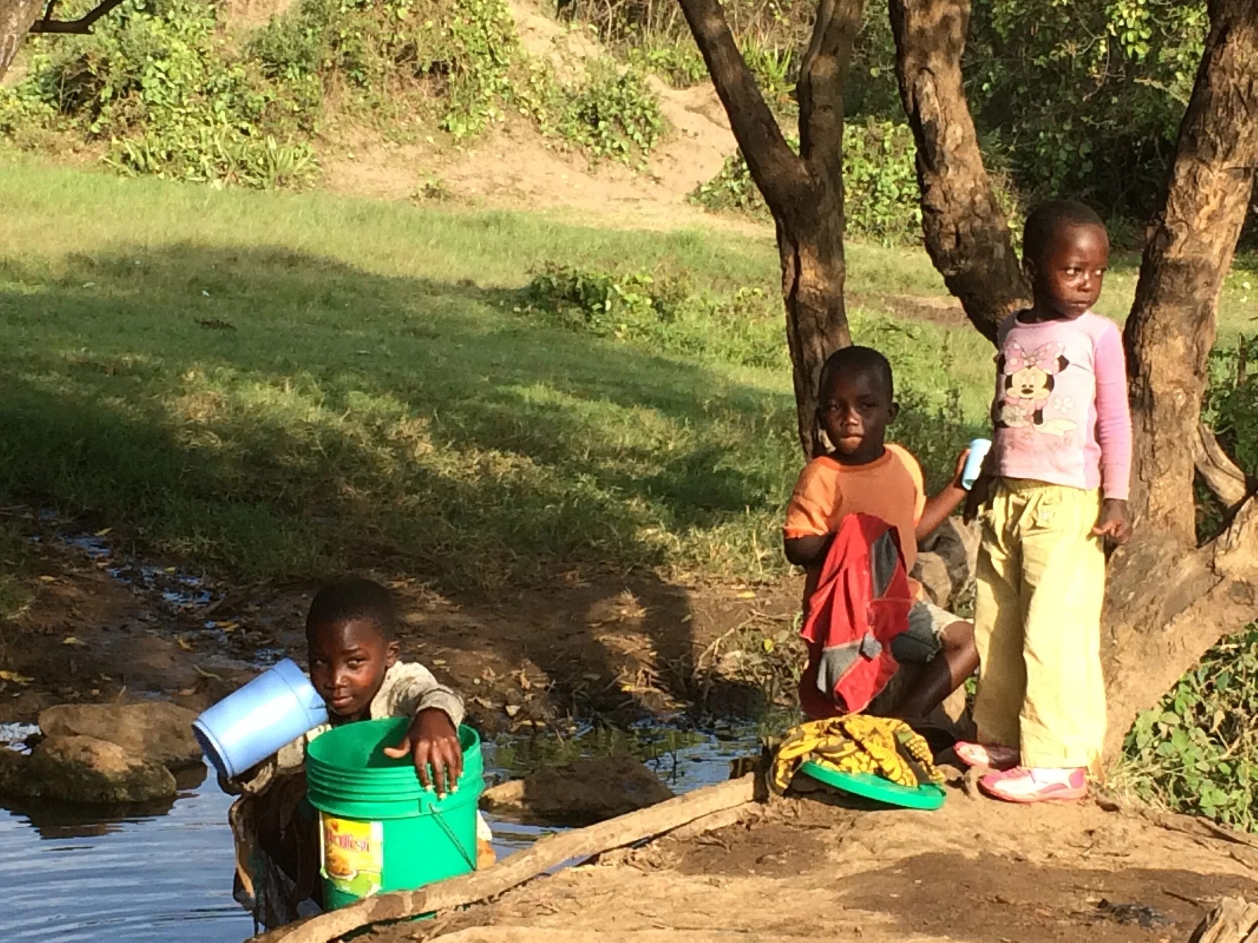 Kids beside river.JPG