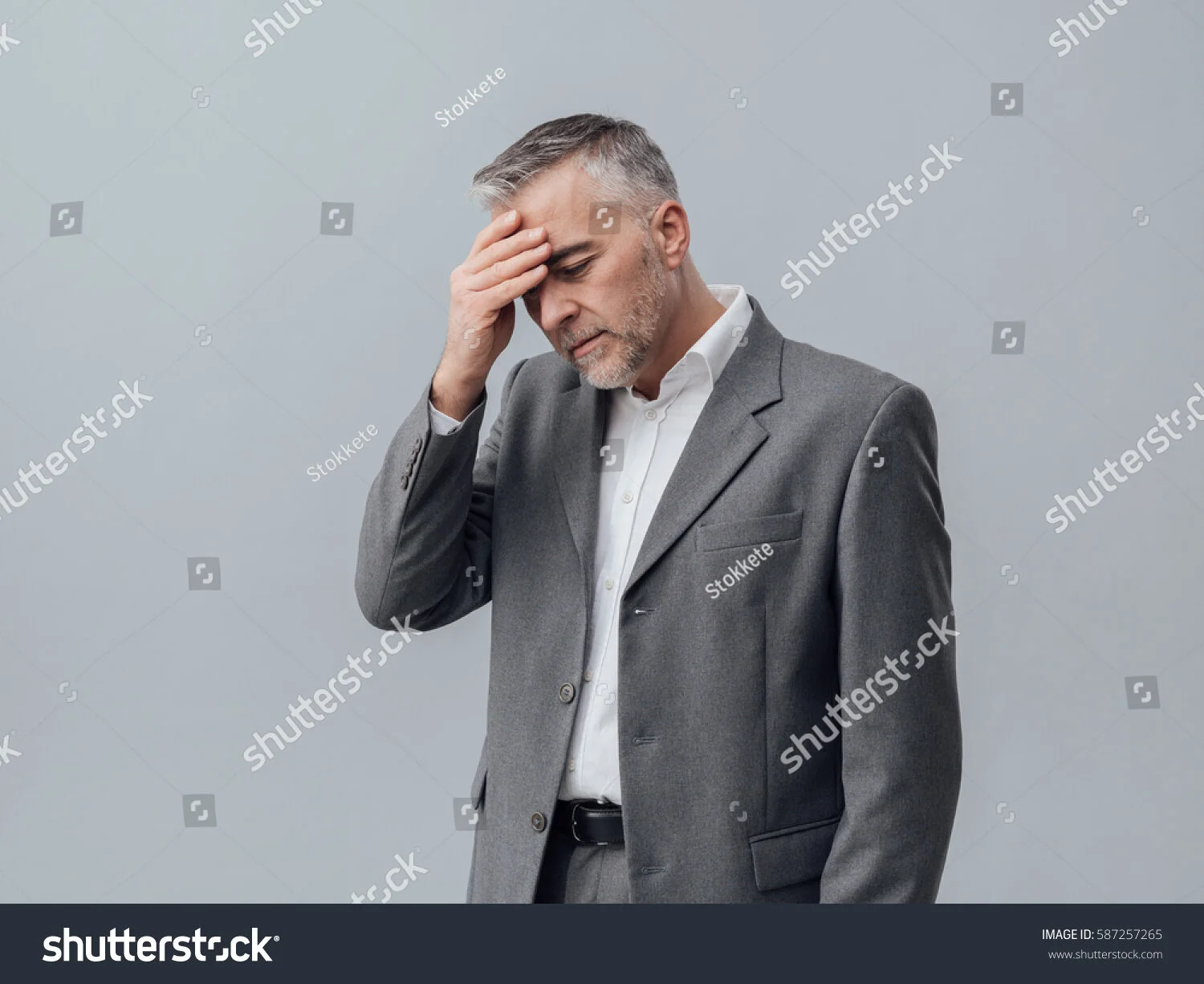 stock-photo-exhausted-businessman-with-headache-he-is-touching-his-forehead-business-failure-and-problems-587257265.jpg