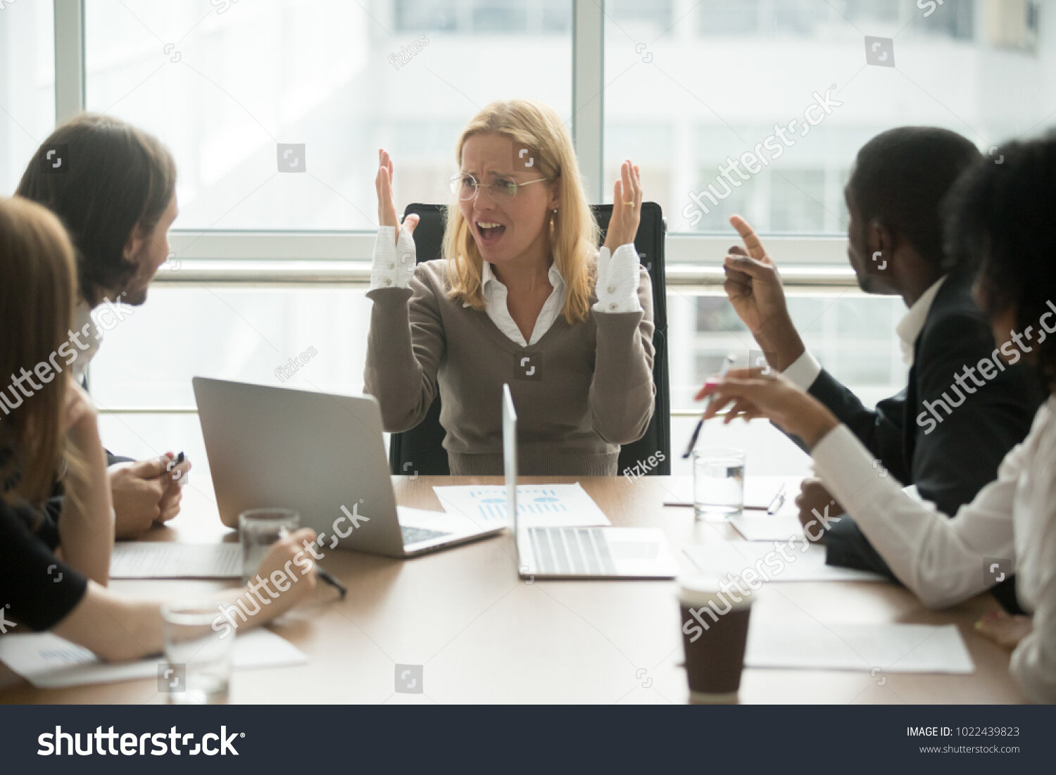 stock-photo-stressed-angry-businesswoman-arguing-at-meeting-with-diverse-male-colleagues-woman-boss-team-1022439823.jpg