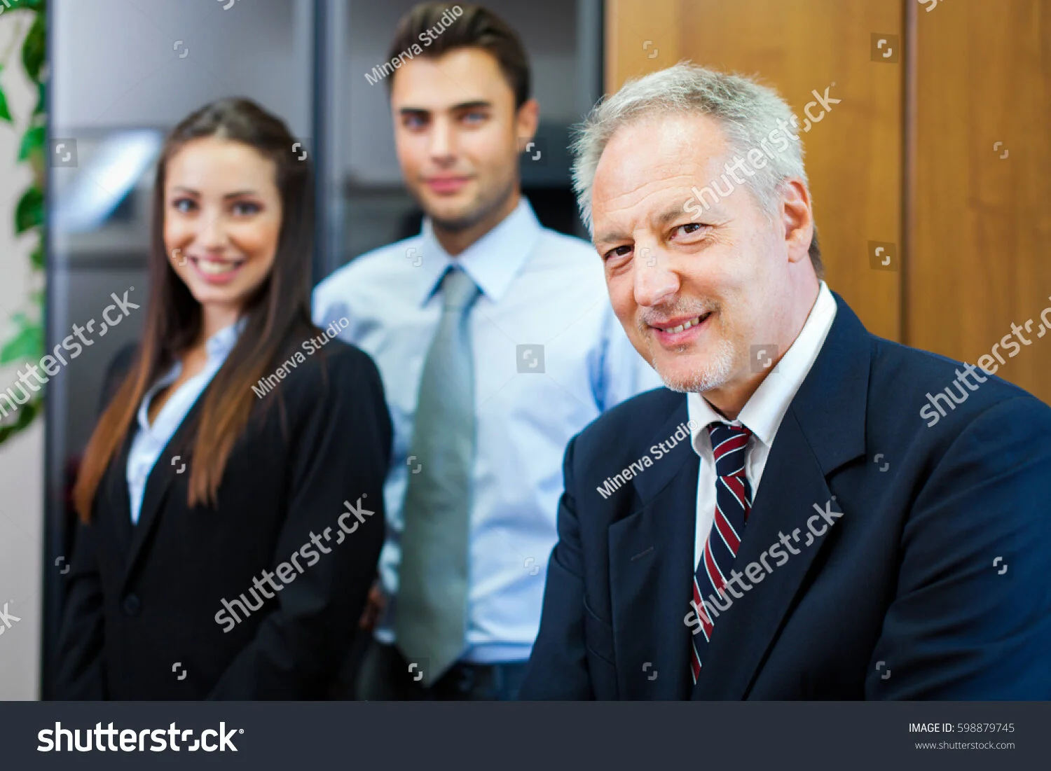 stock-photo--portrait-of-happy-business-partners-looking-at-camera-598879745.jpg