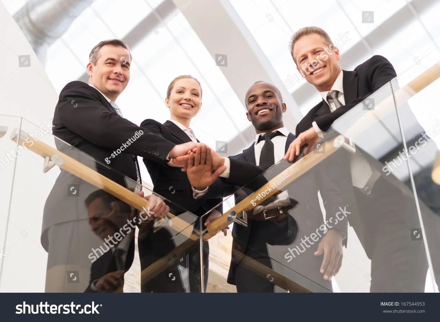 stock-photo-strong-business-team-low-angle-view-of-four-confident-business-people-standing-close-to-each-other-167544953.jpg