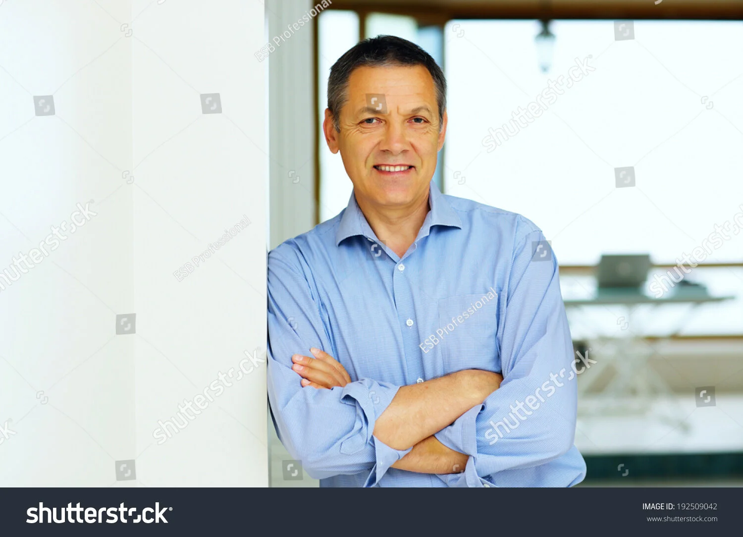 stock-photo-happy-senior-man-with-hands-folded-at-home-192509042.jpg
