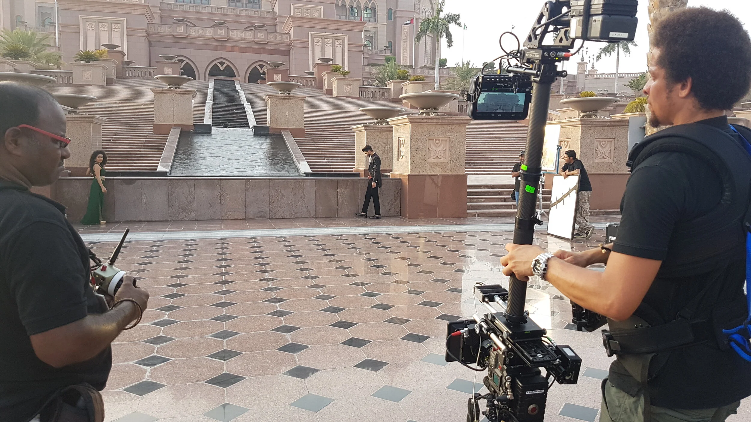Steadicam operator filming on location outside a palace