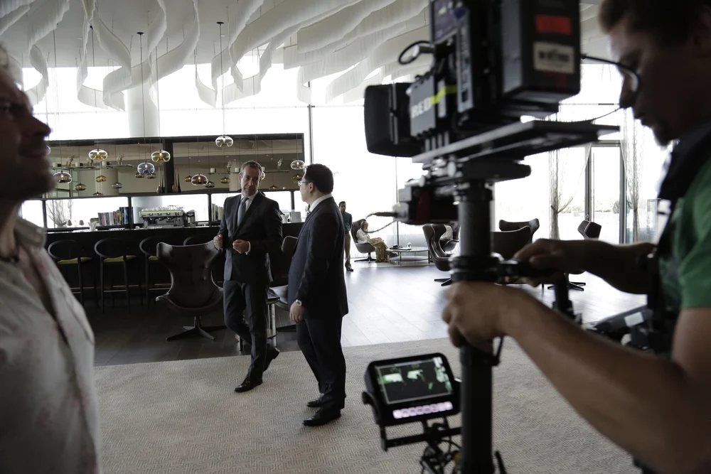Camera operator framing an interior scene with a Steadicam rig