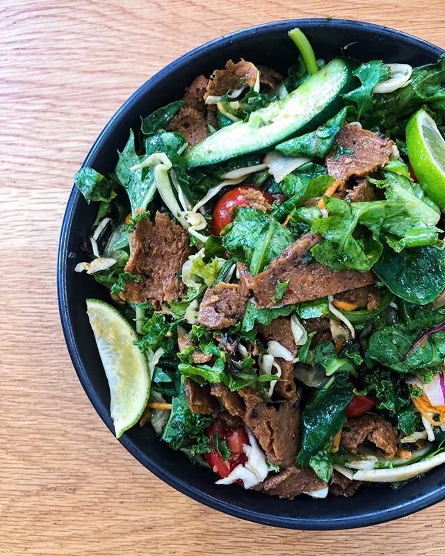 Introducing our newest addition to the menu - VEGAN THAI BEEF SALAD!
. 
We wanted to showcase our house made vegan beef in another dish to show you just how many ways it can be eaten! Mixed in with cashews, cucumbers, cherry toms, salad greens, our fresh kaleslaw for some crunch, topped with a thai dressing and a wedge of lime. It’s the perfect summer dish, fresh & tasty-AF! 👌🏼