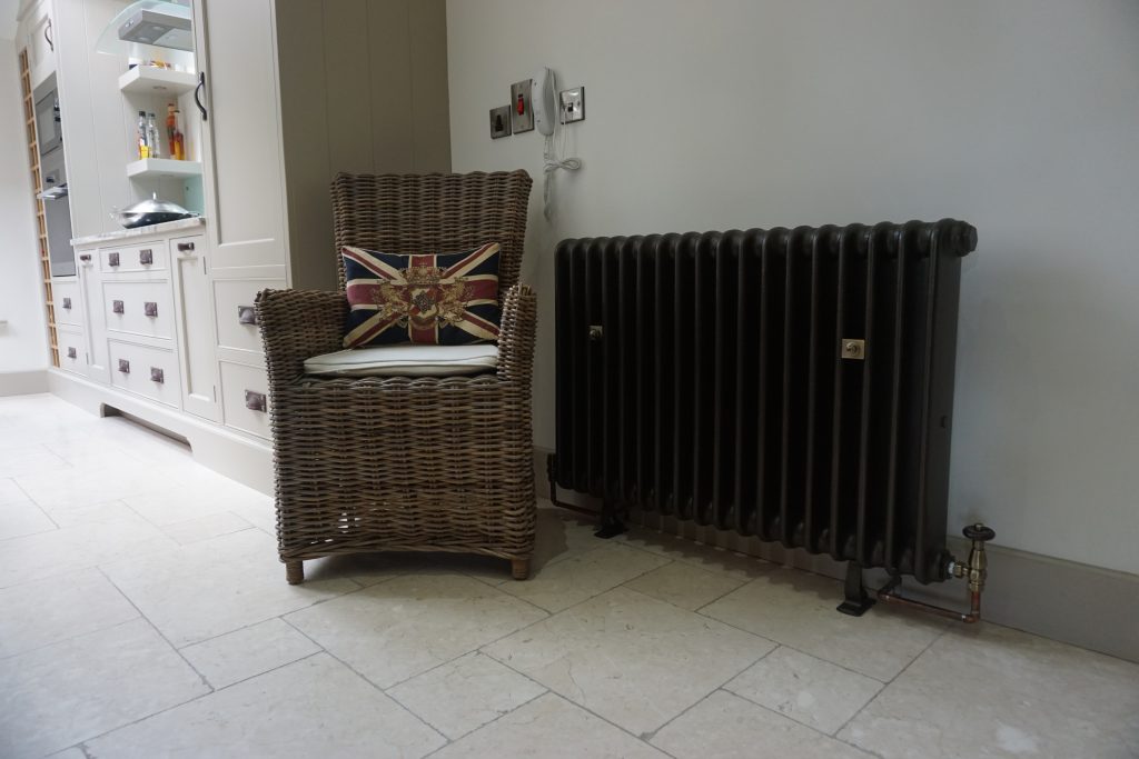 Black renovated Old School cast iron radiator with colour coded feet