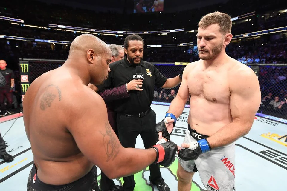 Daniel Cormier and Stipe Miocic touch gloves before their second UFC heavyweight Championship bout at UFC 241. (Credit: Josh Hedges/Zuffa)
