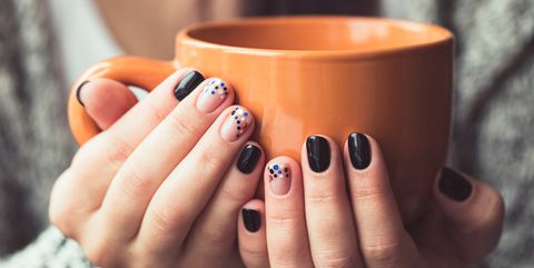 woman-with-beautiful-manicure-holding-a-orange-cup-royalty-free-image-689919352-1535131313.jpg