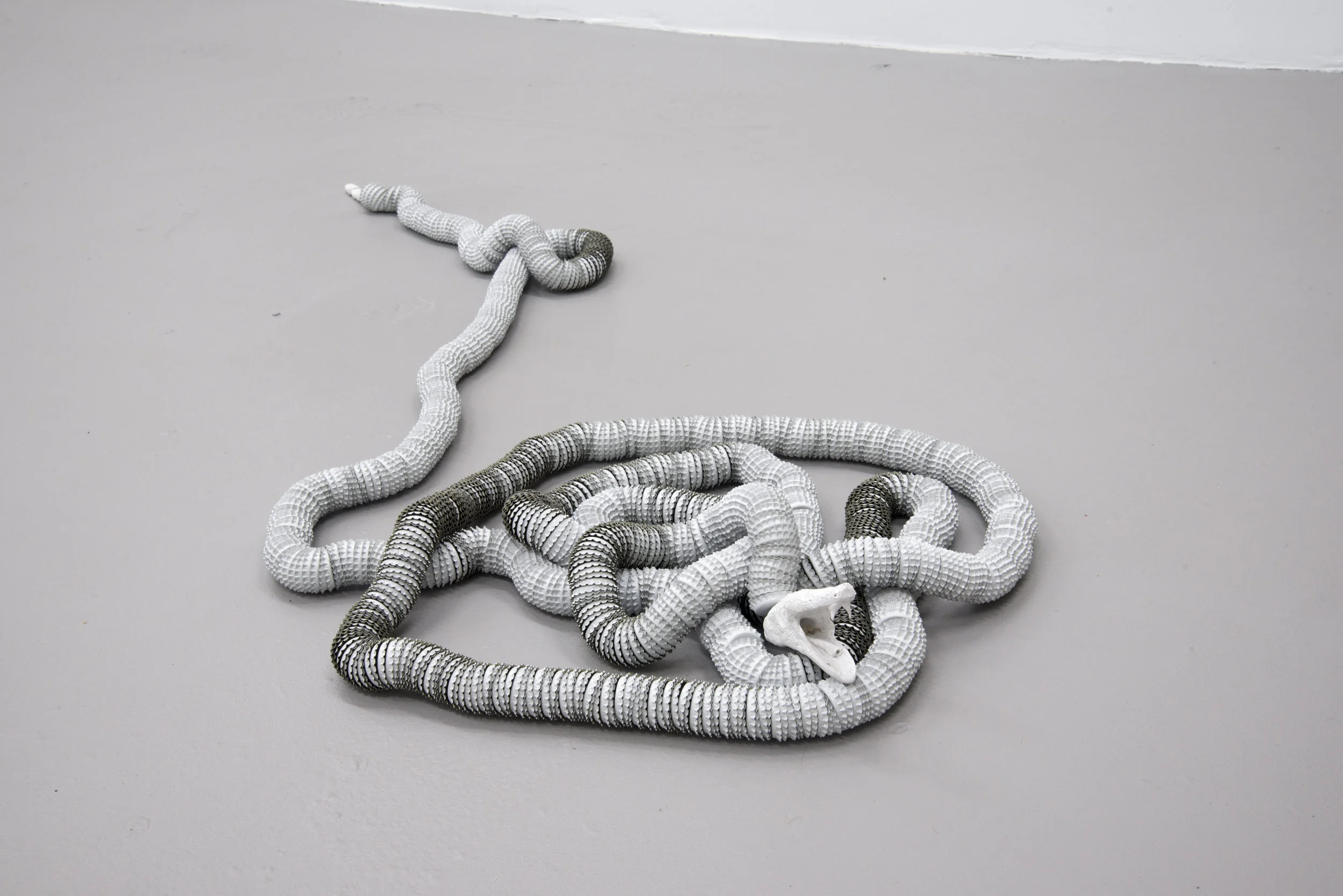 Preparing for the Unknown (Dream Snake), 2019 polymer clay, hemp string, bottle caps 20 feet long, installation dimensions variable
