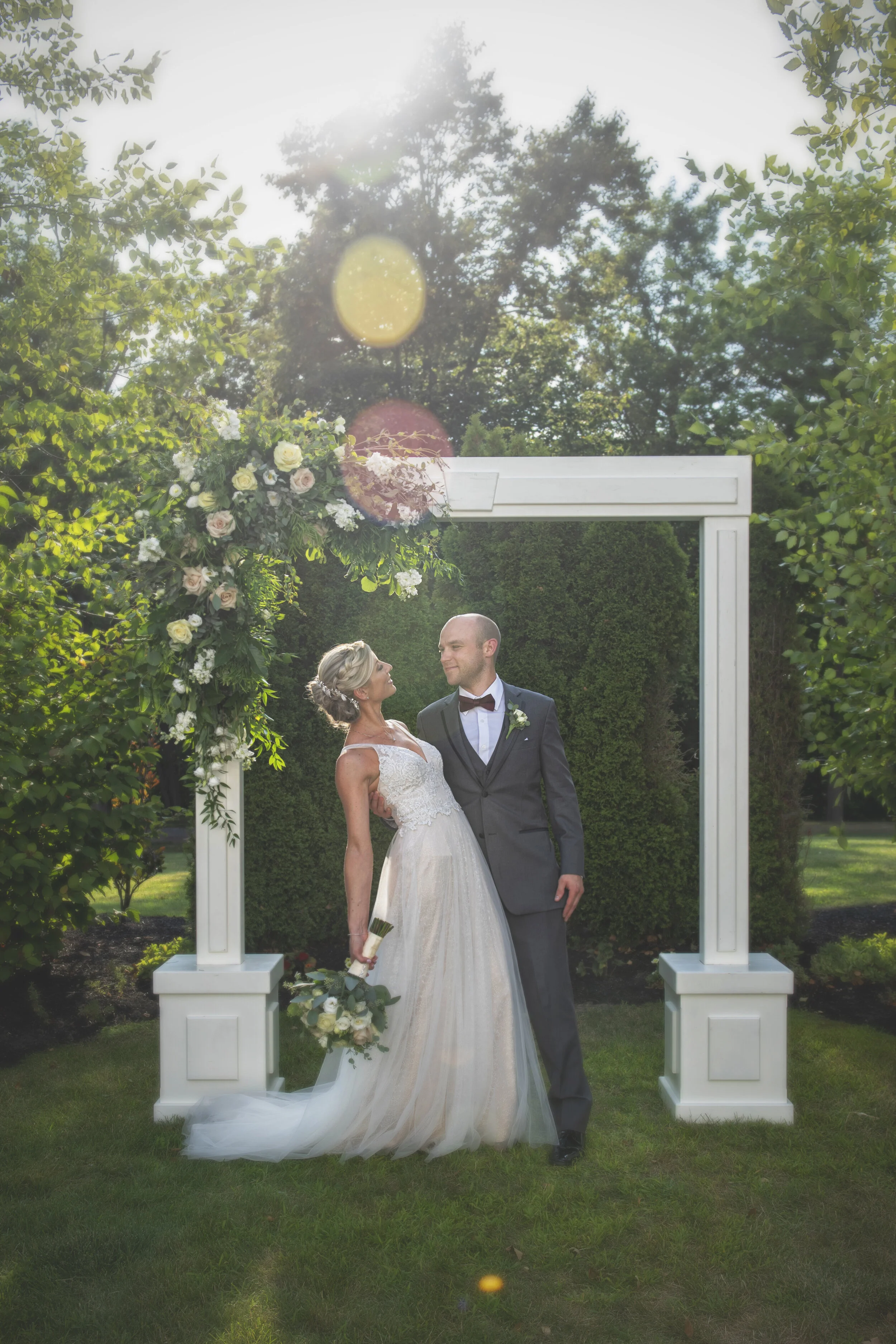 A couple looks lovingly at each other outside the Avanti Mansion 