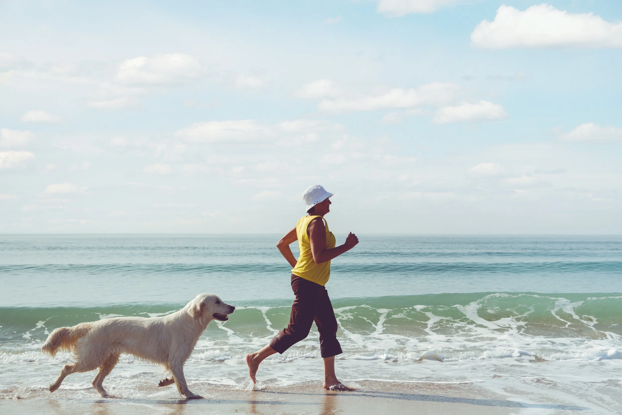 Older woman jogging with her dog
