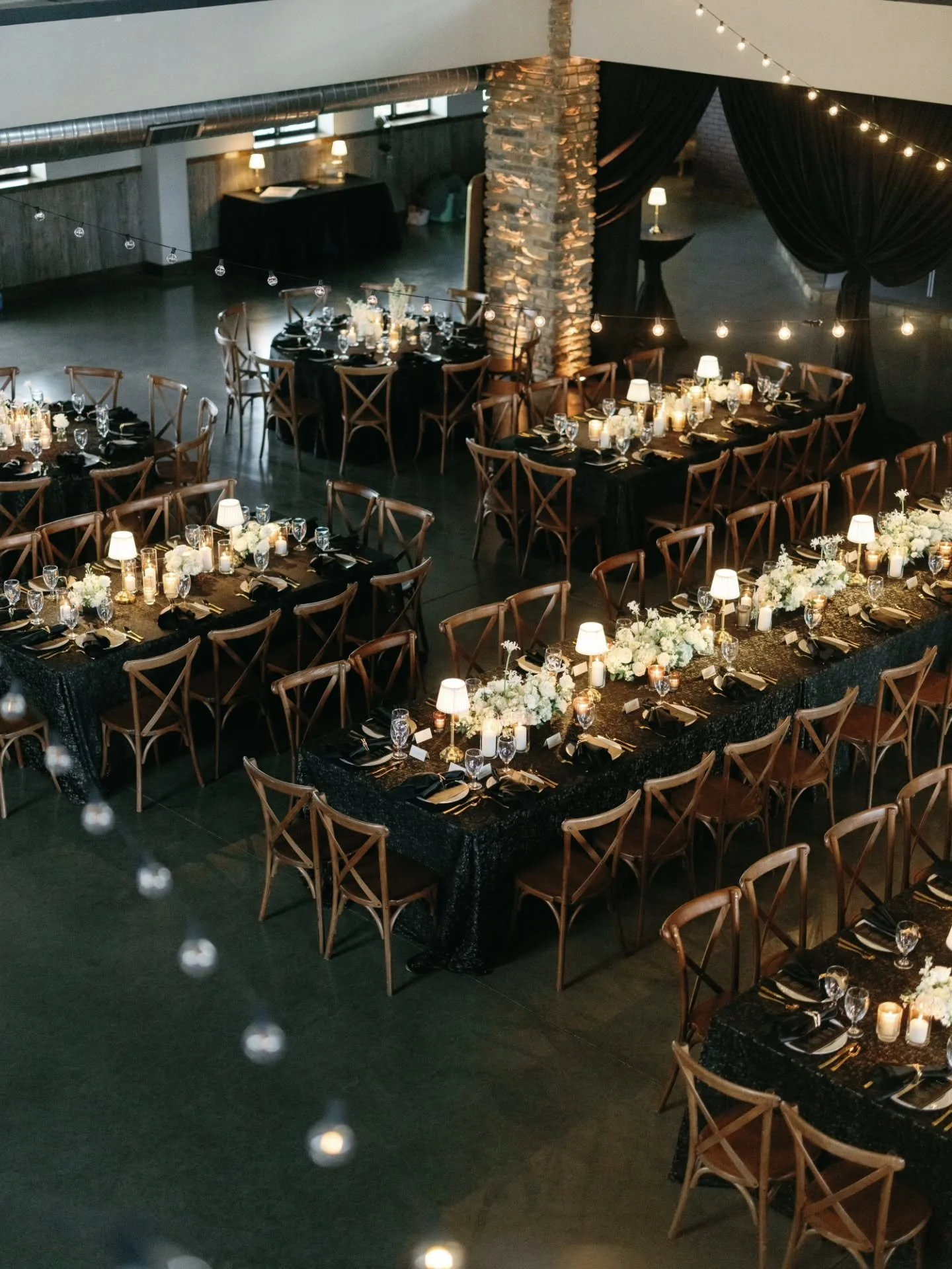 Paige and Greg dreamed of a reception that felt cozy and intimate &mdash; the kind of space where conversations lingered, glasses stayed full, and guests truly saw one another.

We layered candlelight, ambient lighting, and thoughtful design details 