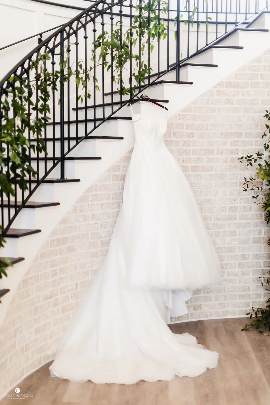Wedding dress hanging on spiral staircase