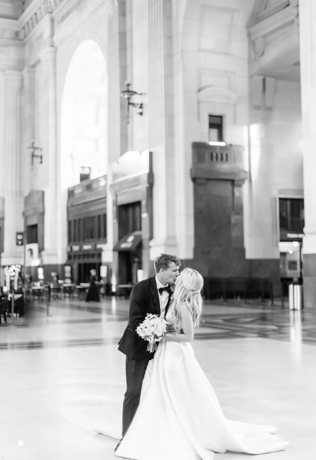 Bride and groom kiss inside Union Station KC