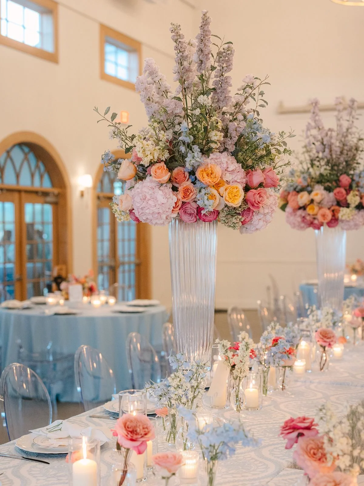 Tall floral centerpiece on wedding reception table