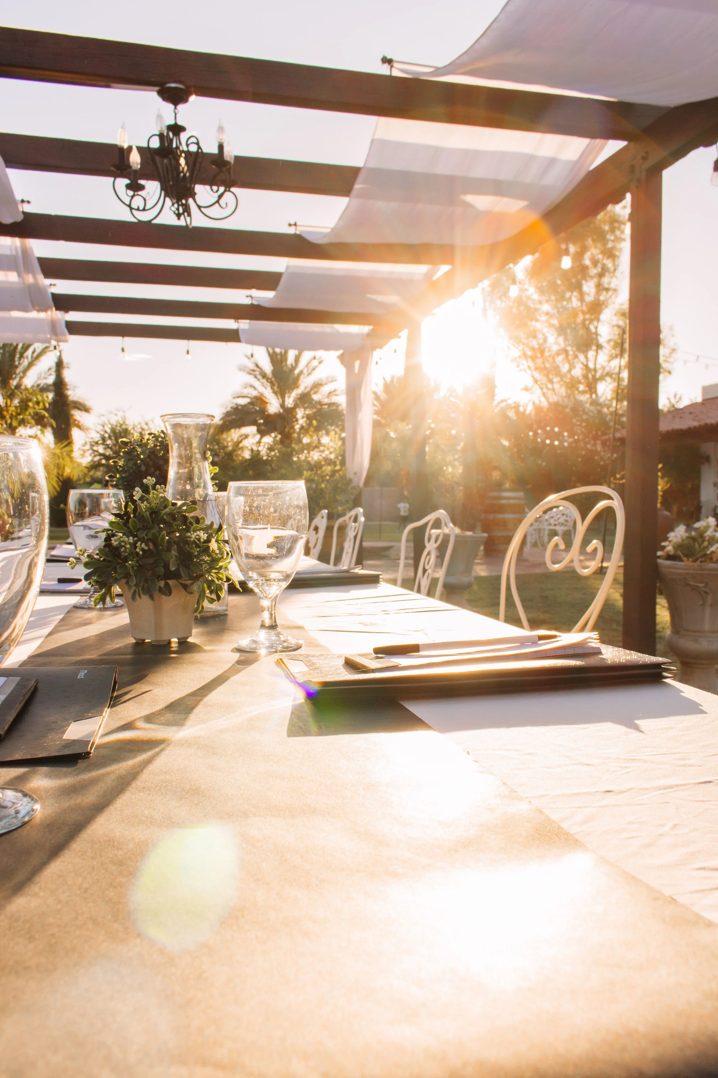 Sunlit executive meeting table beneath Villa de la Meza's outdoor pergola venue.