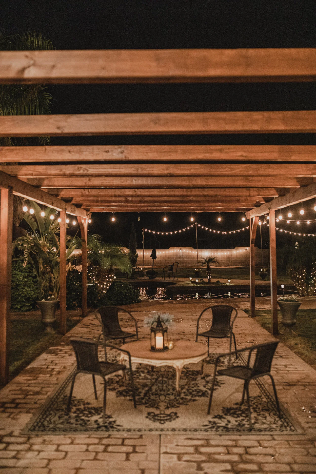 Pergola illuminated with string lights at Villa de la Meza.