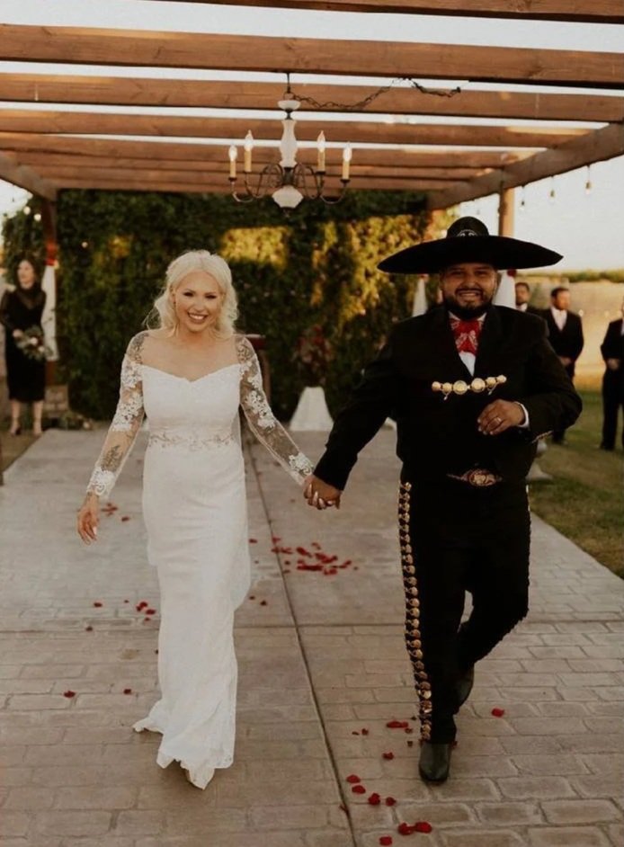 Couple walking hand in hand after their wedding ceremony.