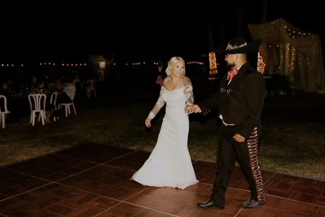 Couple dancing together during an evening wedding reception.