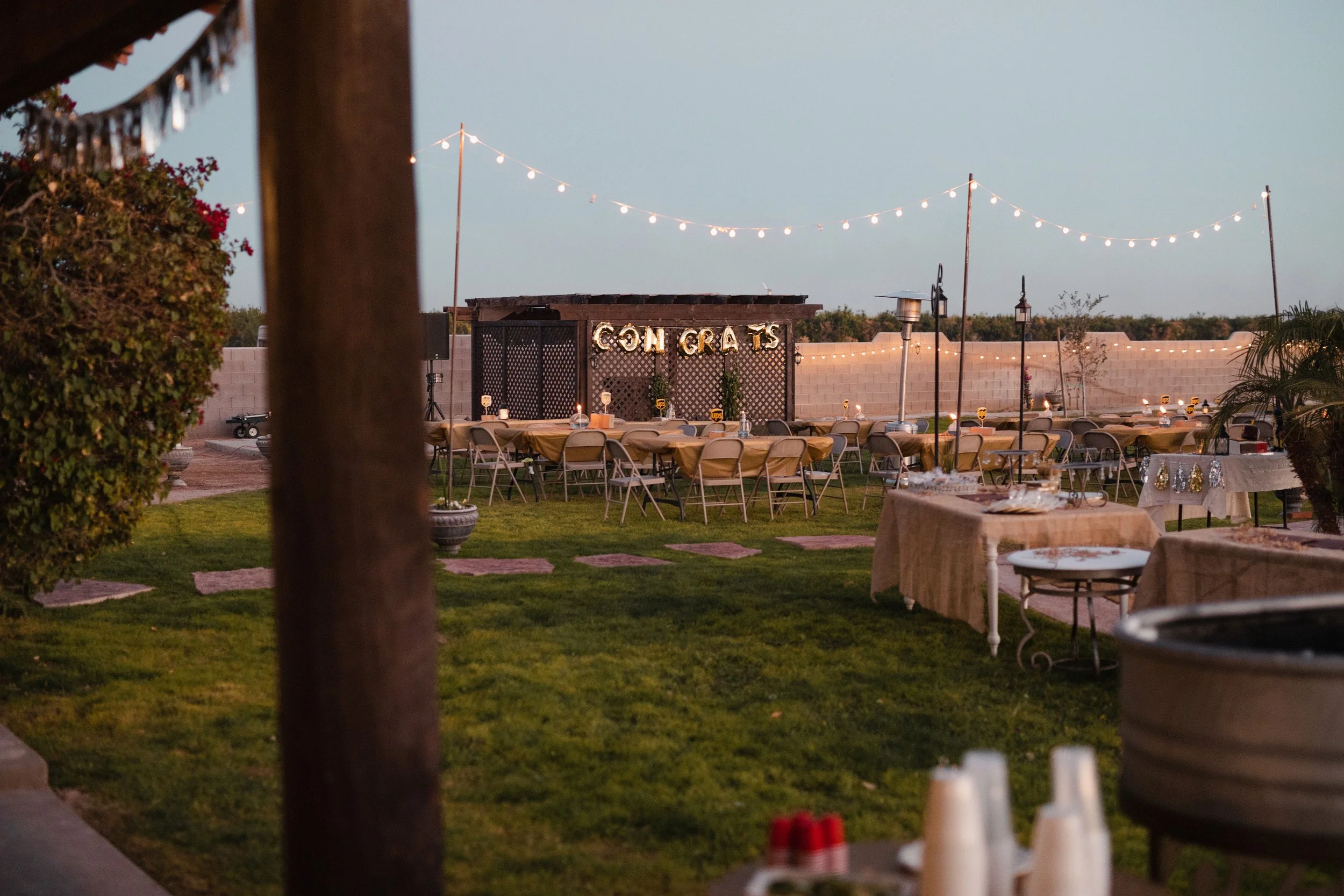 Outdoor event space prepared for guests beneath market lights at Villa de la Meza.