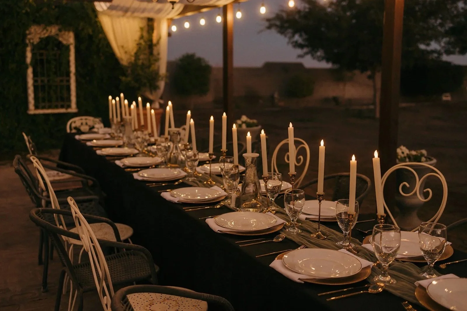 Elegant outdoor private event dinner setup with candlelit tablescape at Villa de la Meza in Yuma, Arizona.