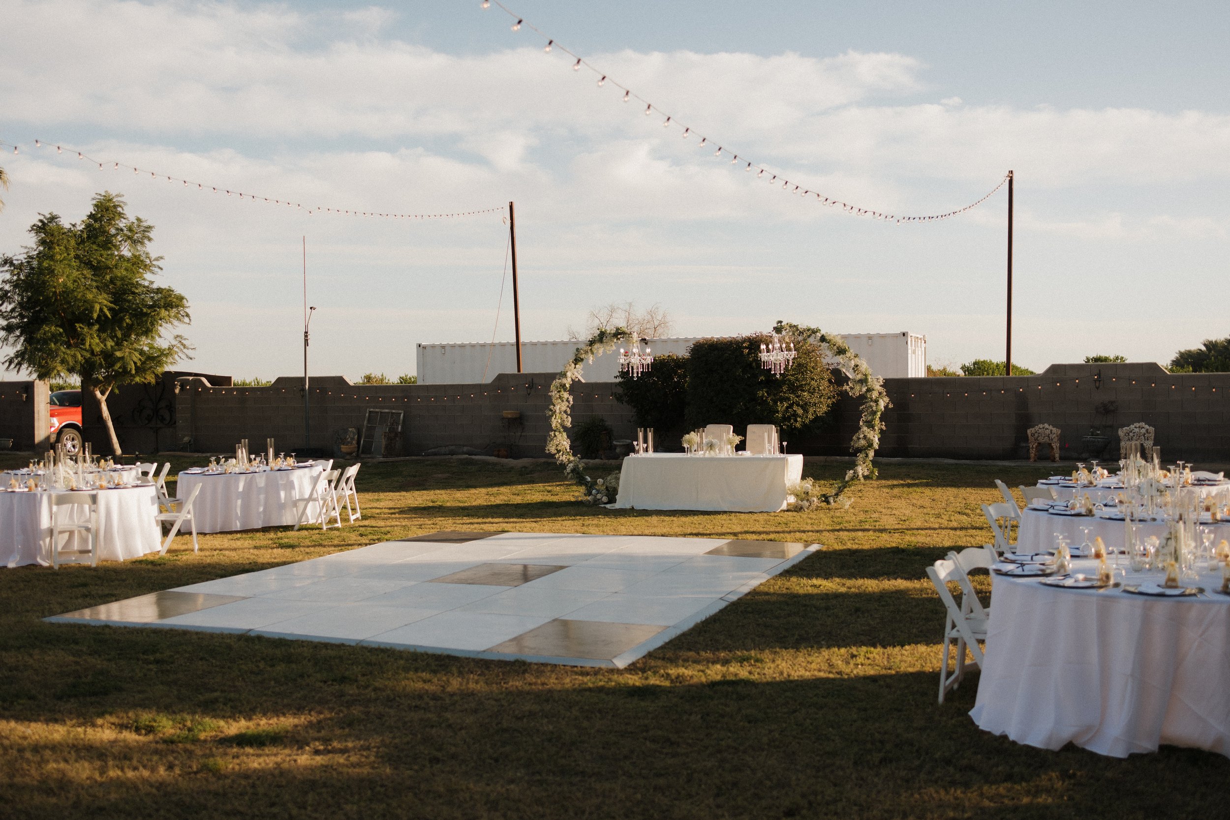Elegant sweetheart table prepared beneath market lights.