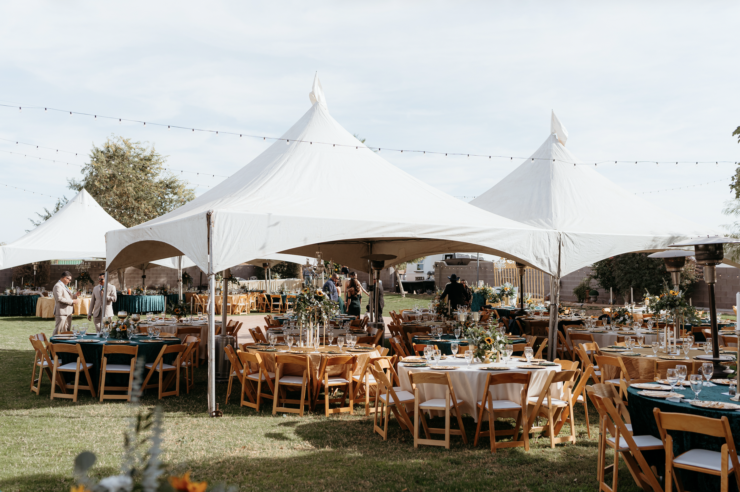 Elegant outdoor wedding reception beneath a sailcloth tent at Villa de la Meza.