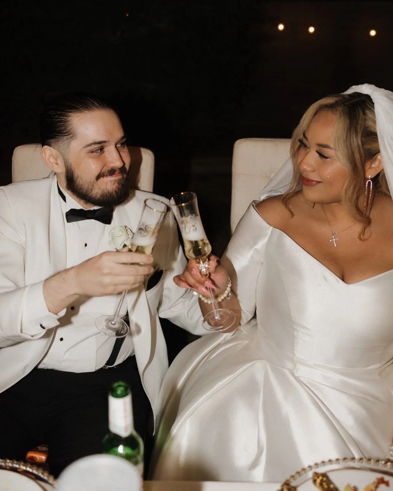Bride and groom enjoying a champagne toast during their wedding reception.
