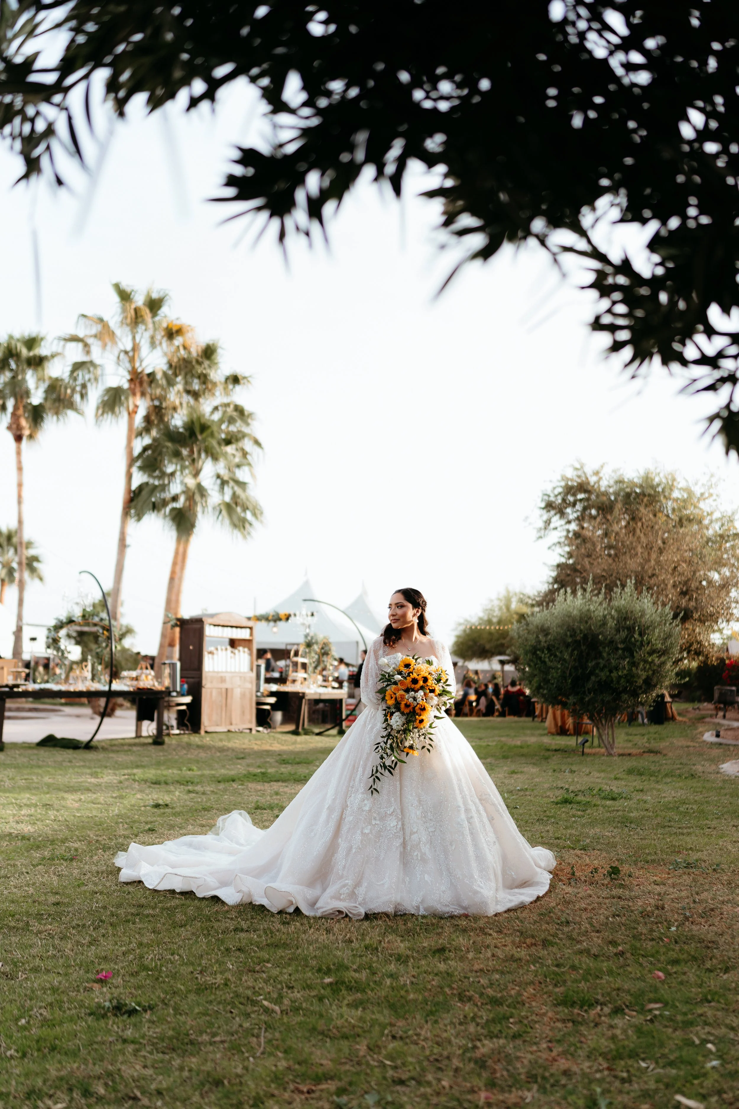 Bride holding a sunflower bouquet after her wedding ceremony.