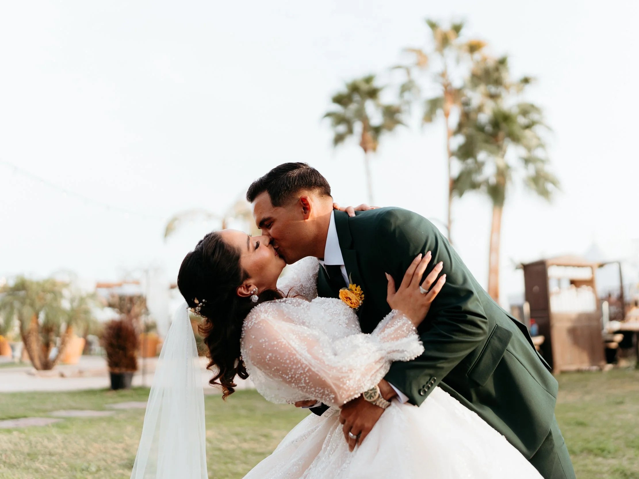 Bride and groom sharing a kiss during their wedding celebration at Villa de la Meza.