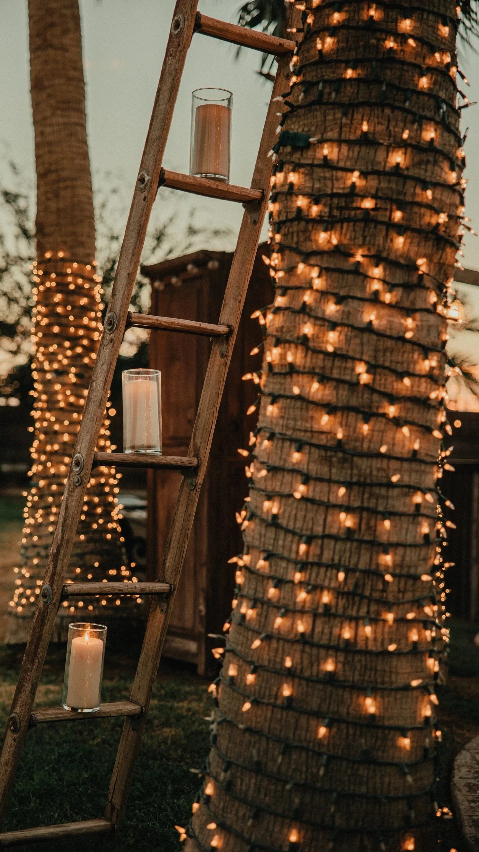 Decorative lanterns and candlelit ladder display creating a romantic evening atmosphere at Villa de la Meza in Yuma, Arizona.