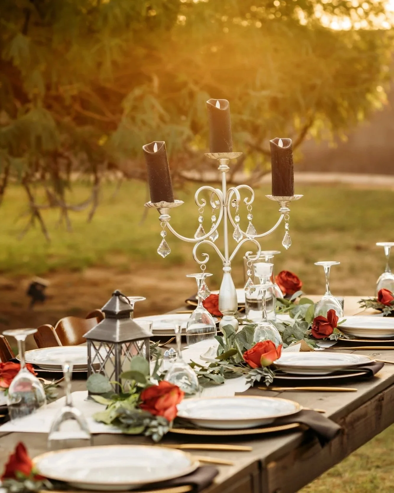 Elegant reception centerpiece with crystal candleholders and floral details.