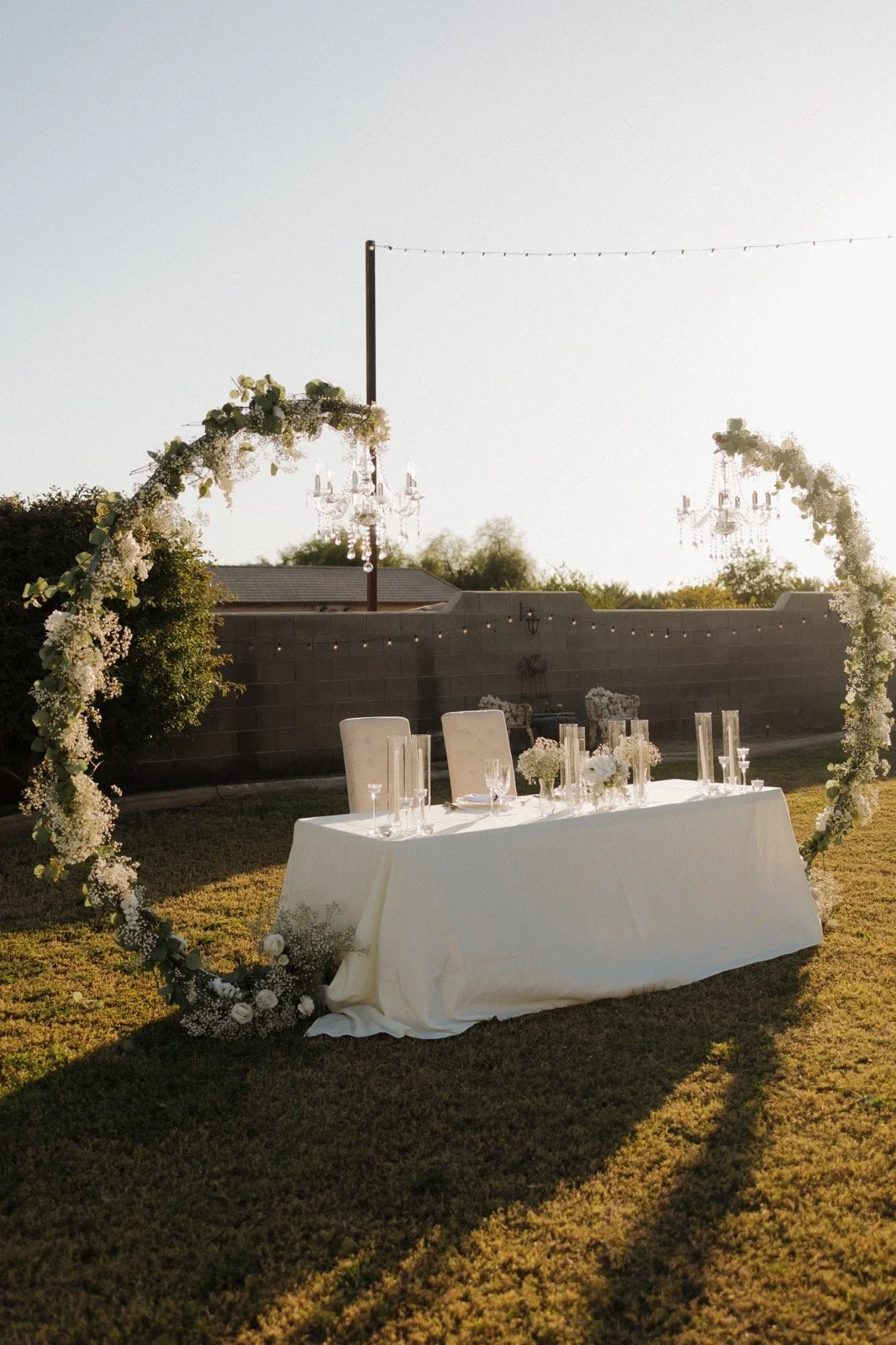 Sweetheart table decorated with floral ceremony arches at Villa de la Meza.