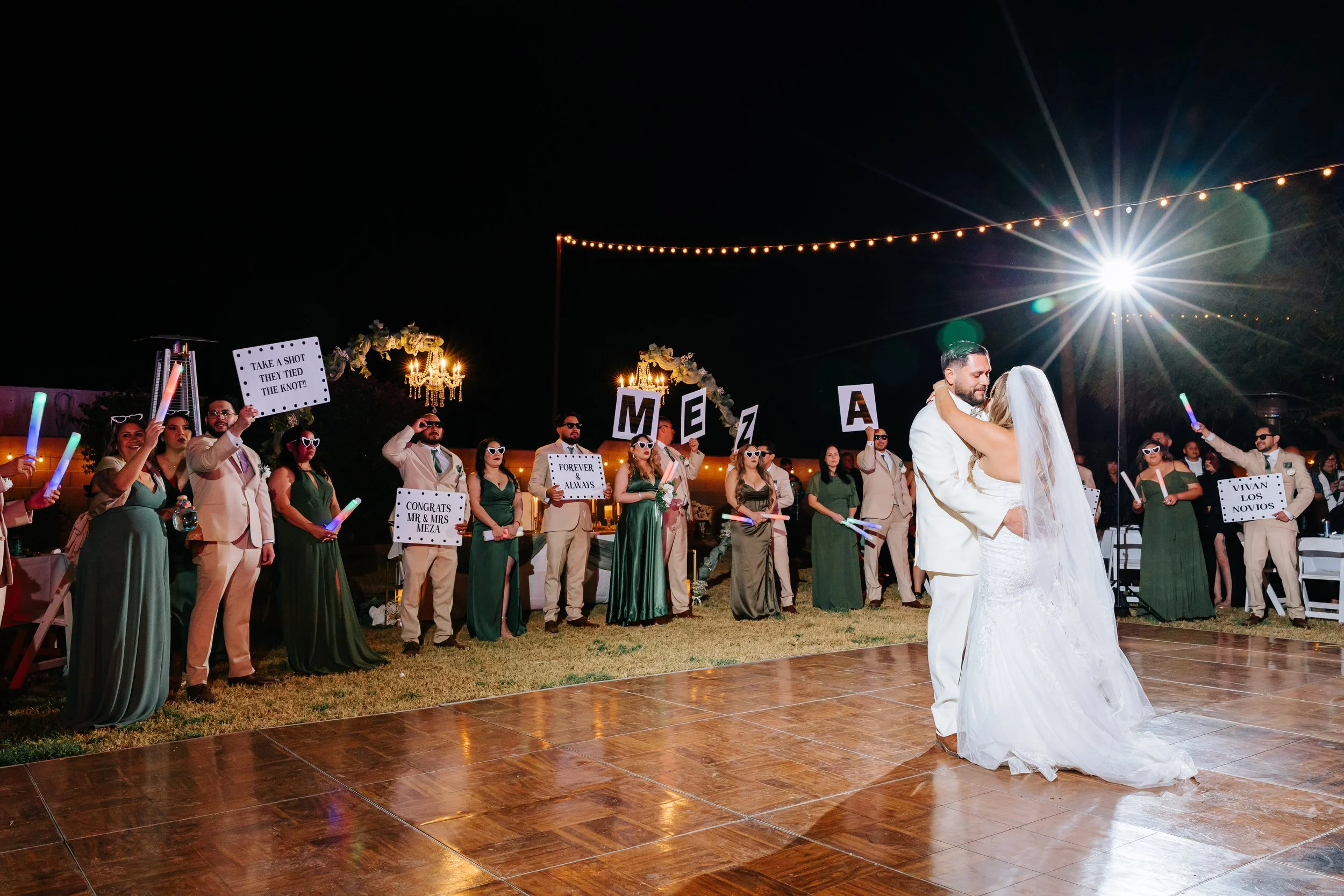 Bride and groom sharing their first dance surrounded by family and friends at Villa de la Meza.