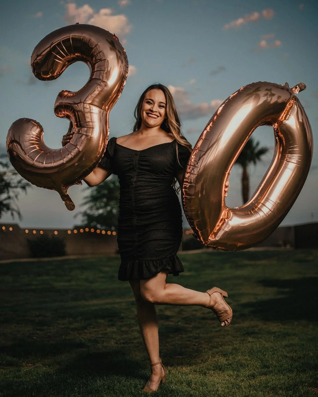 Guest celebrating a milestone birthday with oversized number balloons at Villa de la Meza.