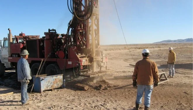 Crew drilling monitoring well