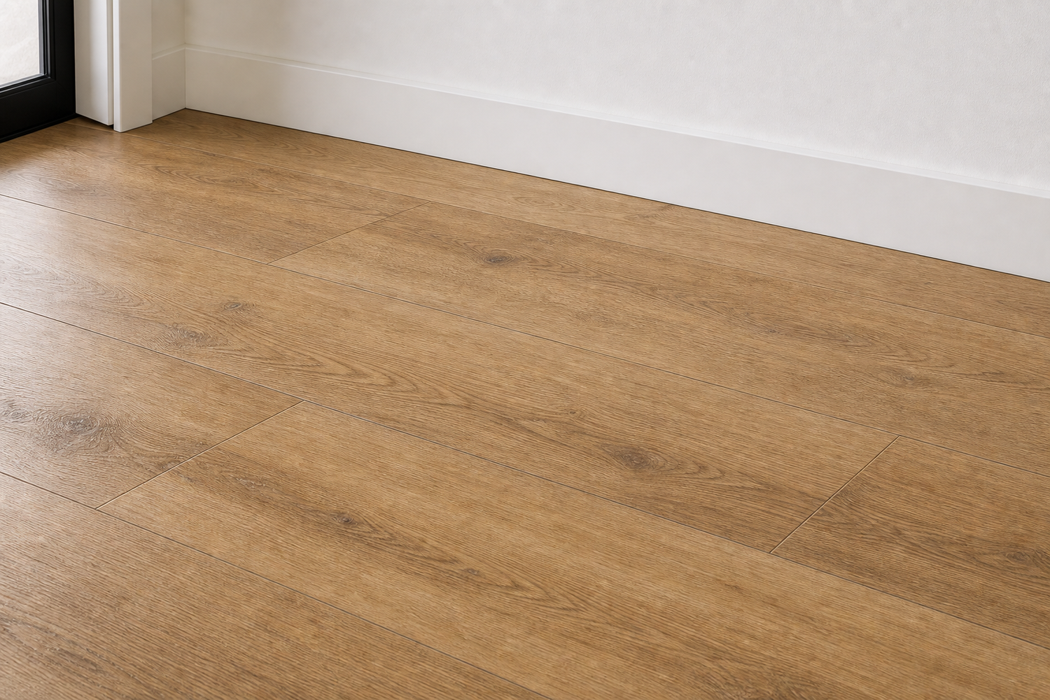 Close detail of Serene Path laminate installed with white baseboard