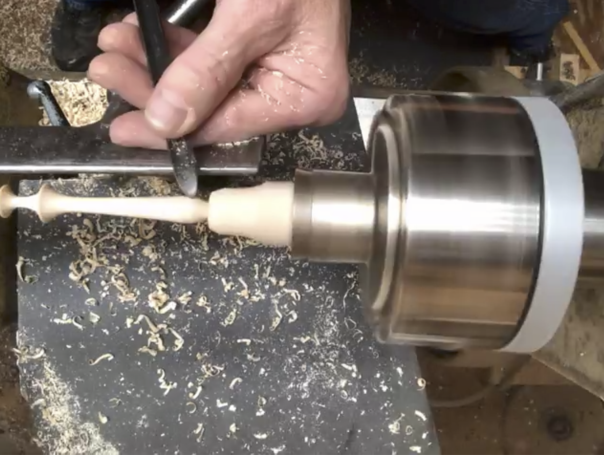  Turning the finial handle. 