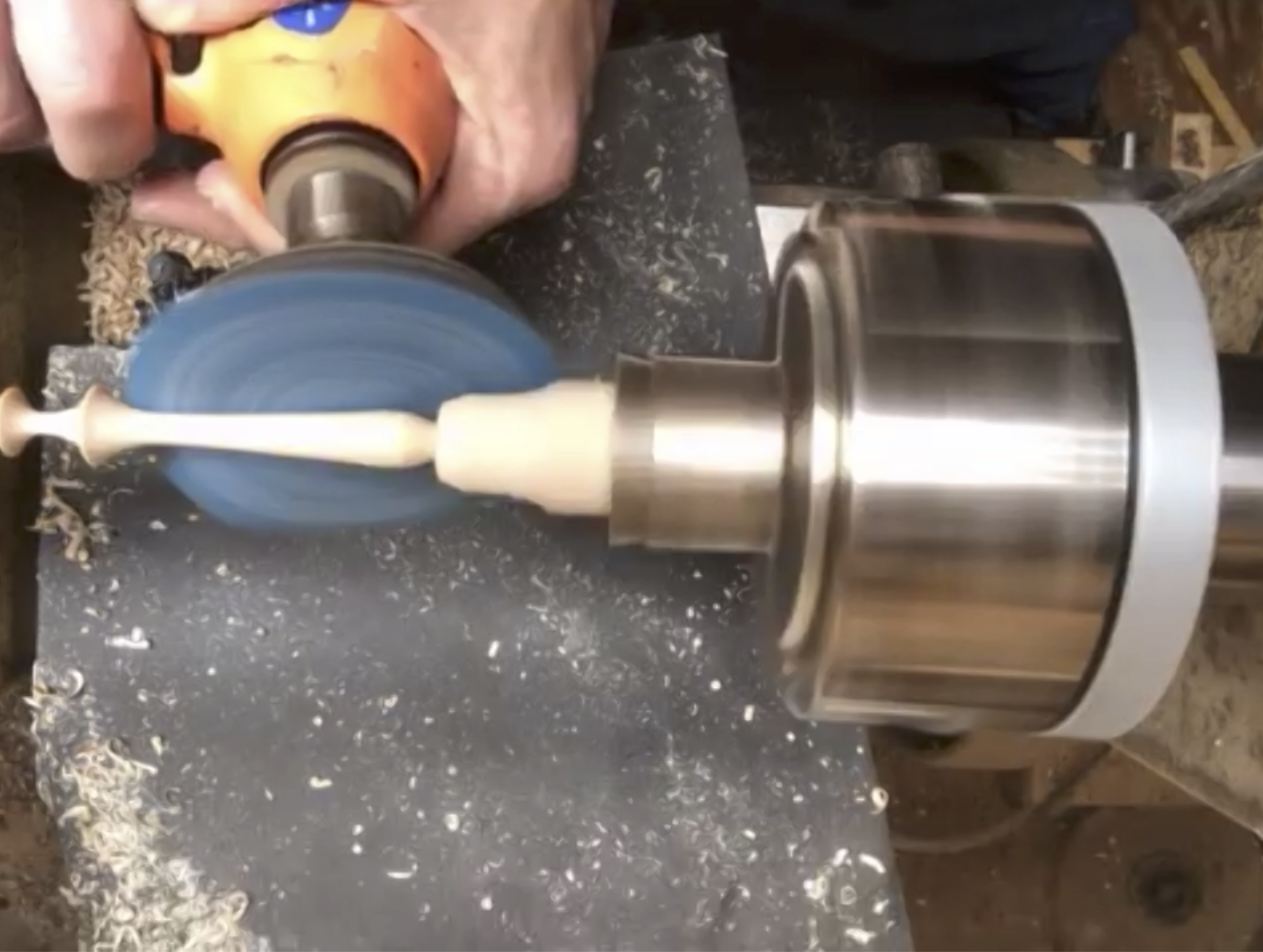  Power sanding the finial handle. 