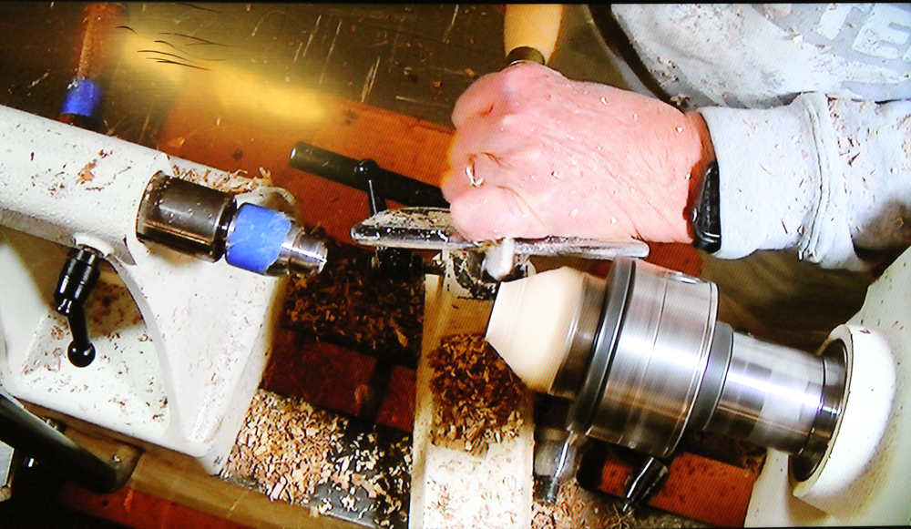  Cutting a wooden chuck to turn the sphere. 