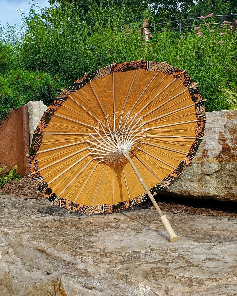 conichalcite handmade parasol interior, medium size, with afro-inspired design on a stone slab