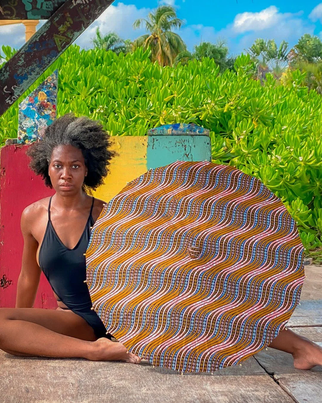 Rooted in stillness and radiating quiet power, this Divine Warrior holds the Eclogite Parasol &mdash; a reflection of balance, endurance, and transformation through pressure.

Seated at the crossroads of color and calm, she embodies the essence of gr