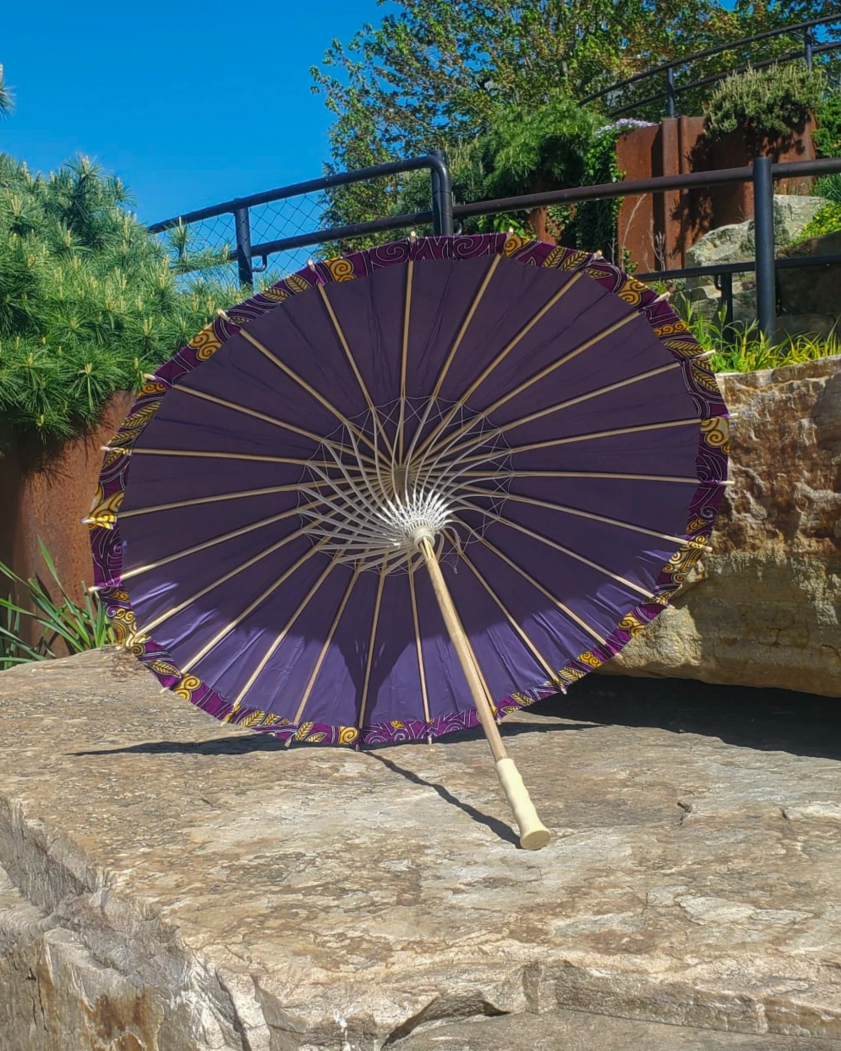 coquimbite handmade parasol interior, medium size, with afro-inspired design on a stone slab