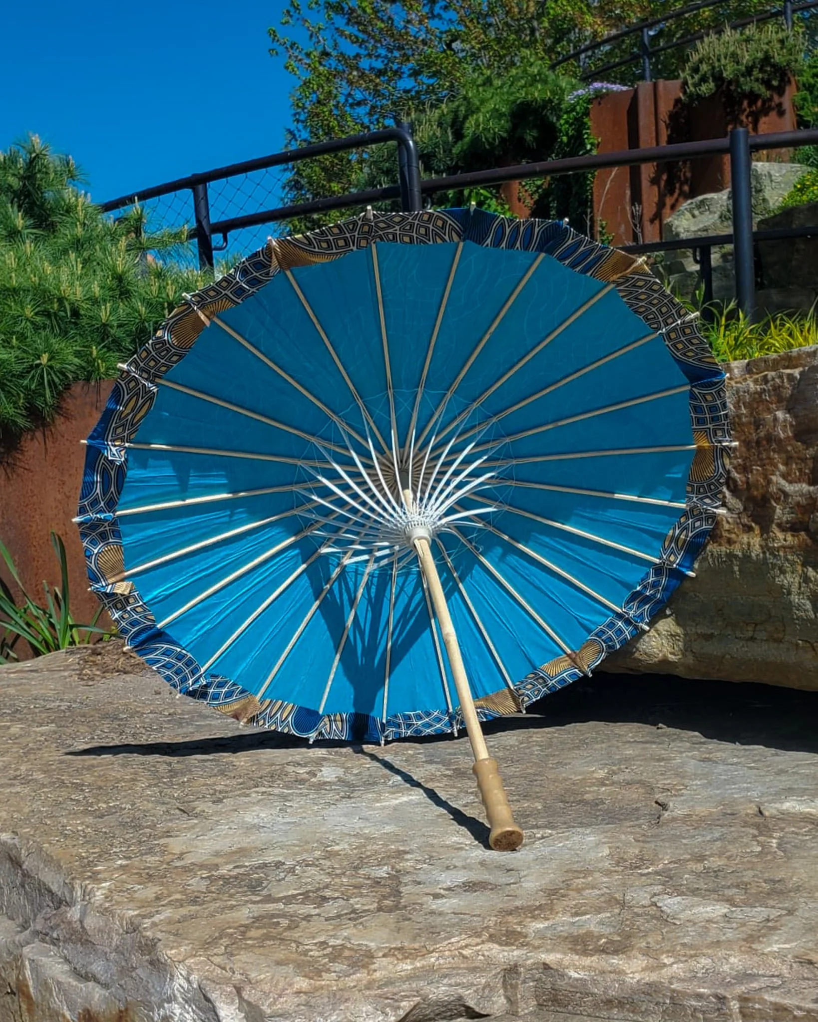 blue onyx handmade parasol interior, medium size, with afro-inspired design on a stone slab