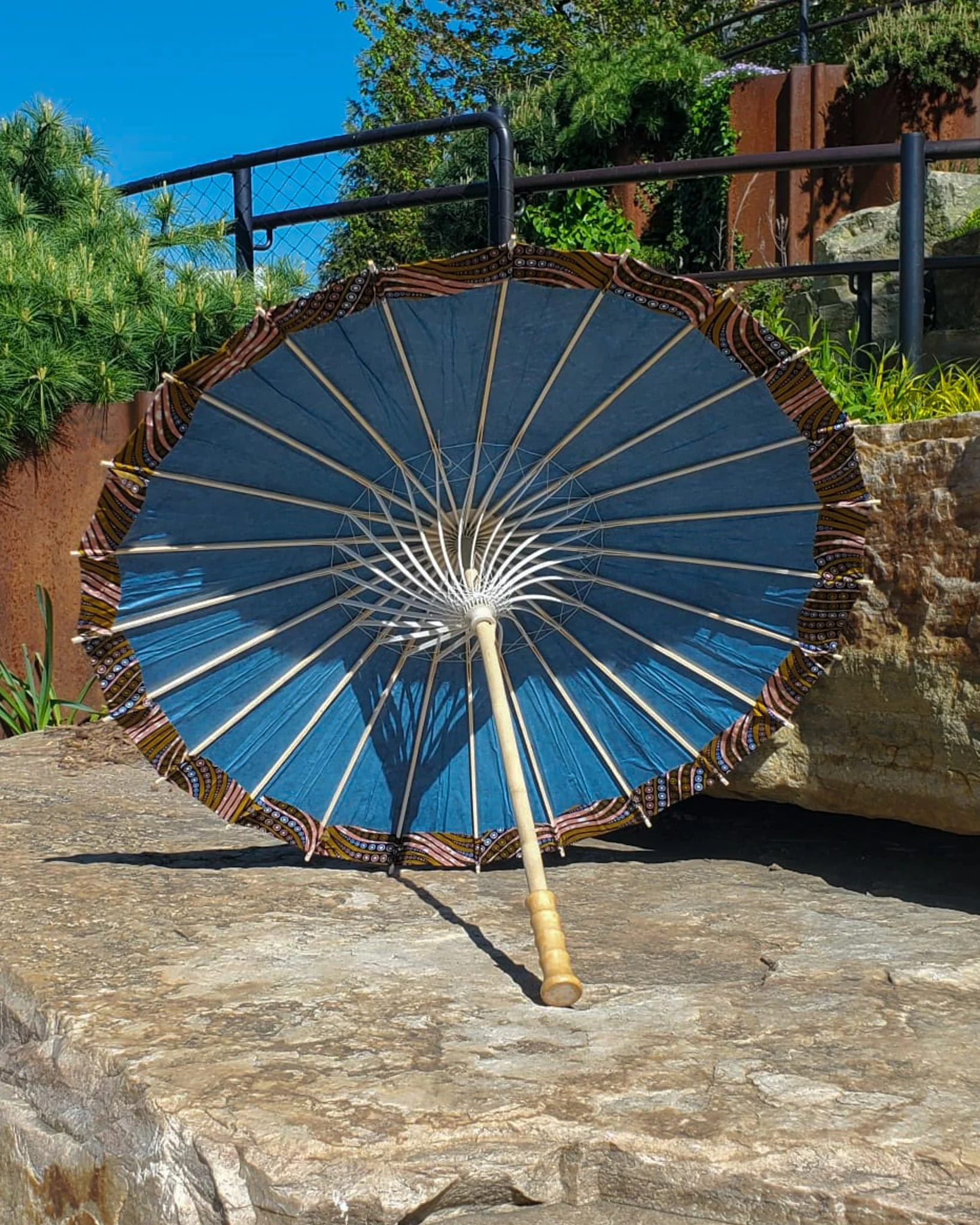 eclogite handmade parasol interior, medium size, with afro-inspired design on a stone slab