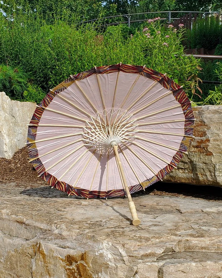 strawberry quartz handmade parasol interior, medium size, with afro-inspired design on a stone slab