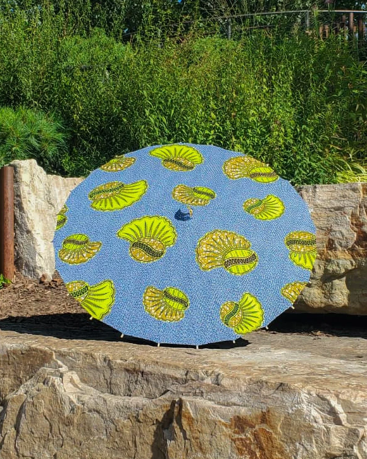 azurmalachite handmade parasol exterior, medium sized, with afro-inspired design on a stone slab