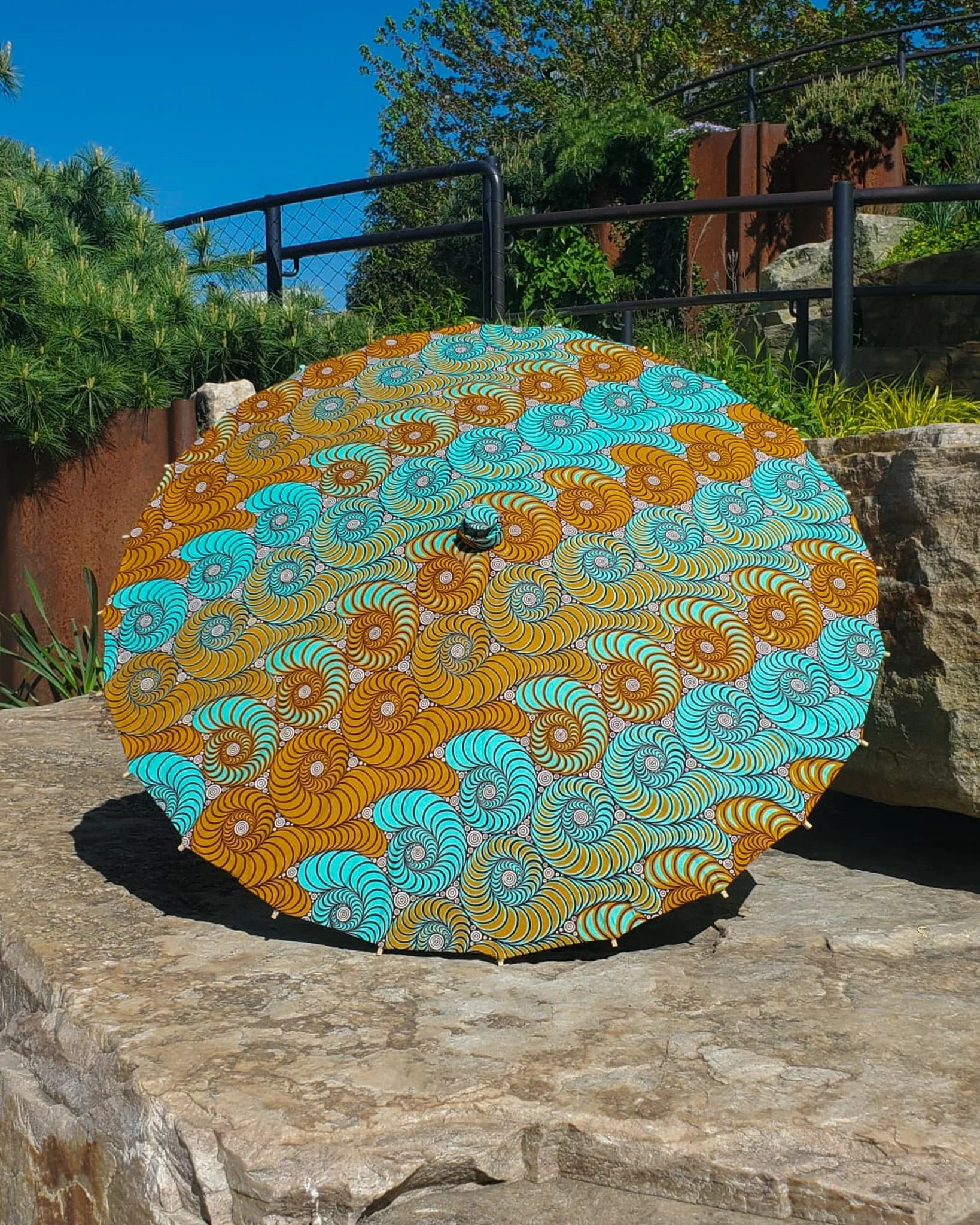 aurichalcite handmade parasol exterior, medium sized, with afro-inspired design on s stone slab