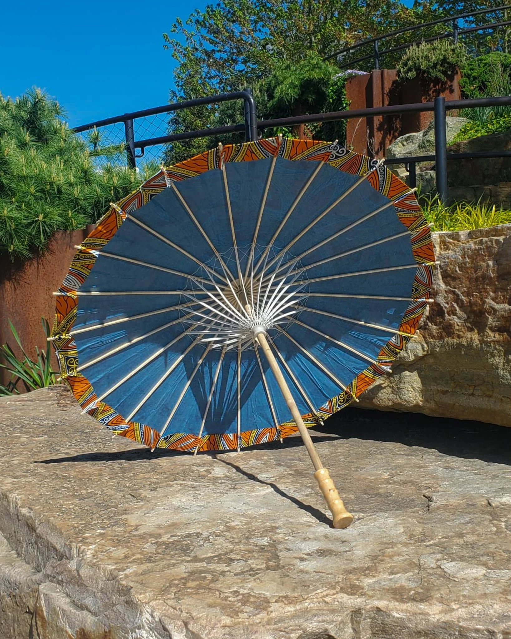 nellite handmade parasol interior, medium size, with afro-inspired design on a stone slab