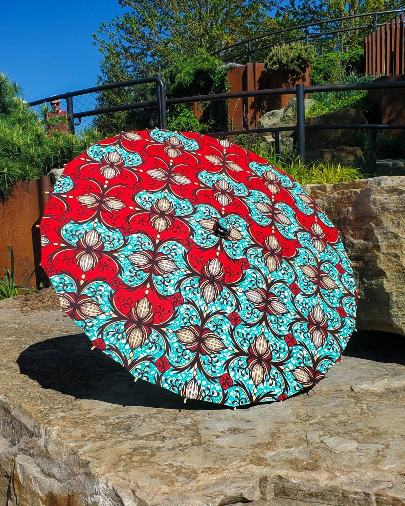 chrysocolla handmade parasol exterior, medium size, with afro-inspired design on a stone slab